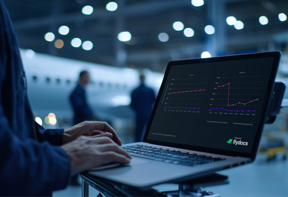Person using laptop displaying analytics dashboard in aircraft hangar with jet in background